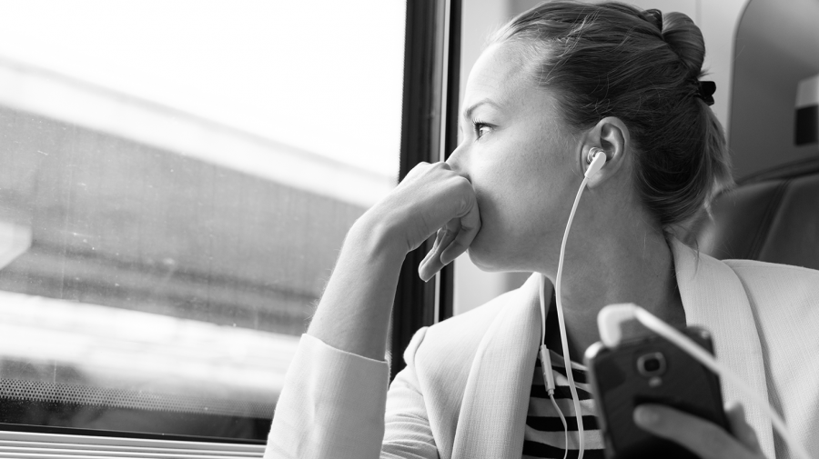 Kvinder i et tog med høretelefoner i ørene